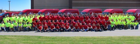 Group photo of Monona Plumbing and Fire Protection team in safety gear.