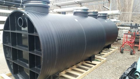 Large black underground storage tank for fire protection and plumbing systems.