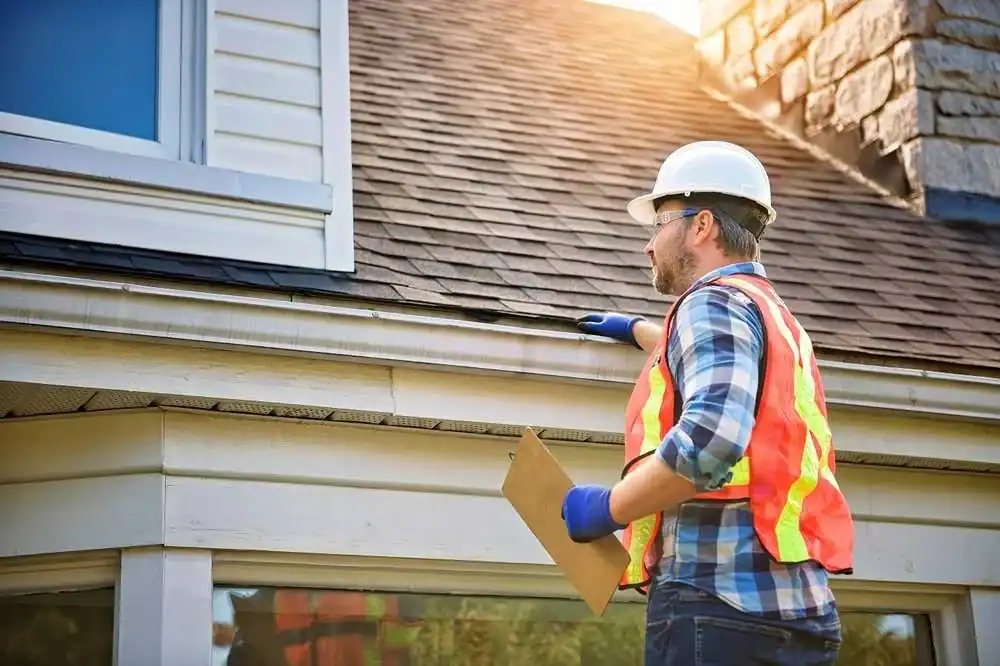 Plumber inspecting roof for fire protection and plumbing systems.