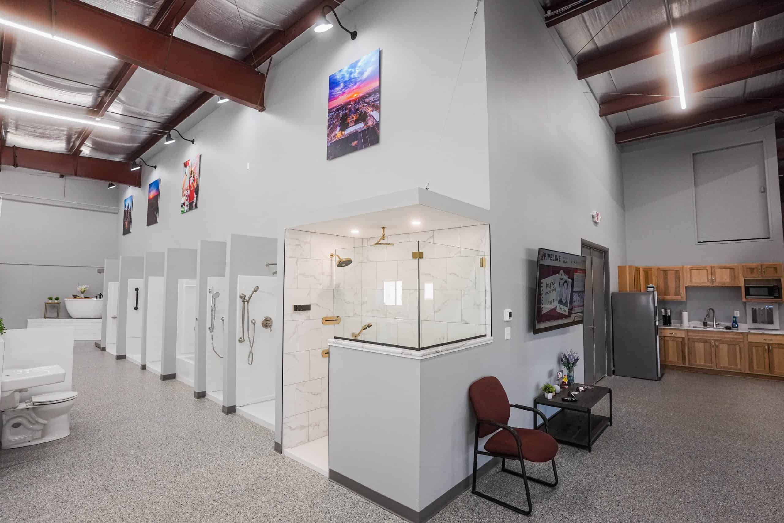 Public restroom with multiple stalls and shower area in Monona, Wisconsin.