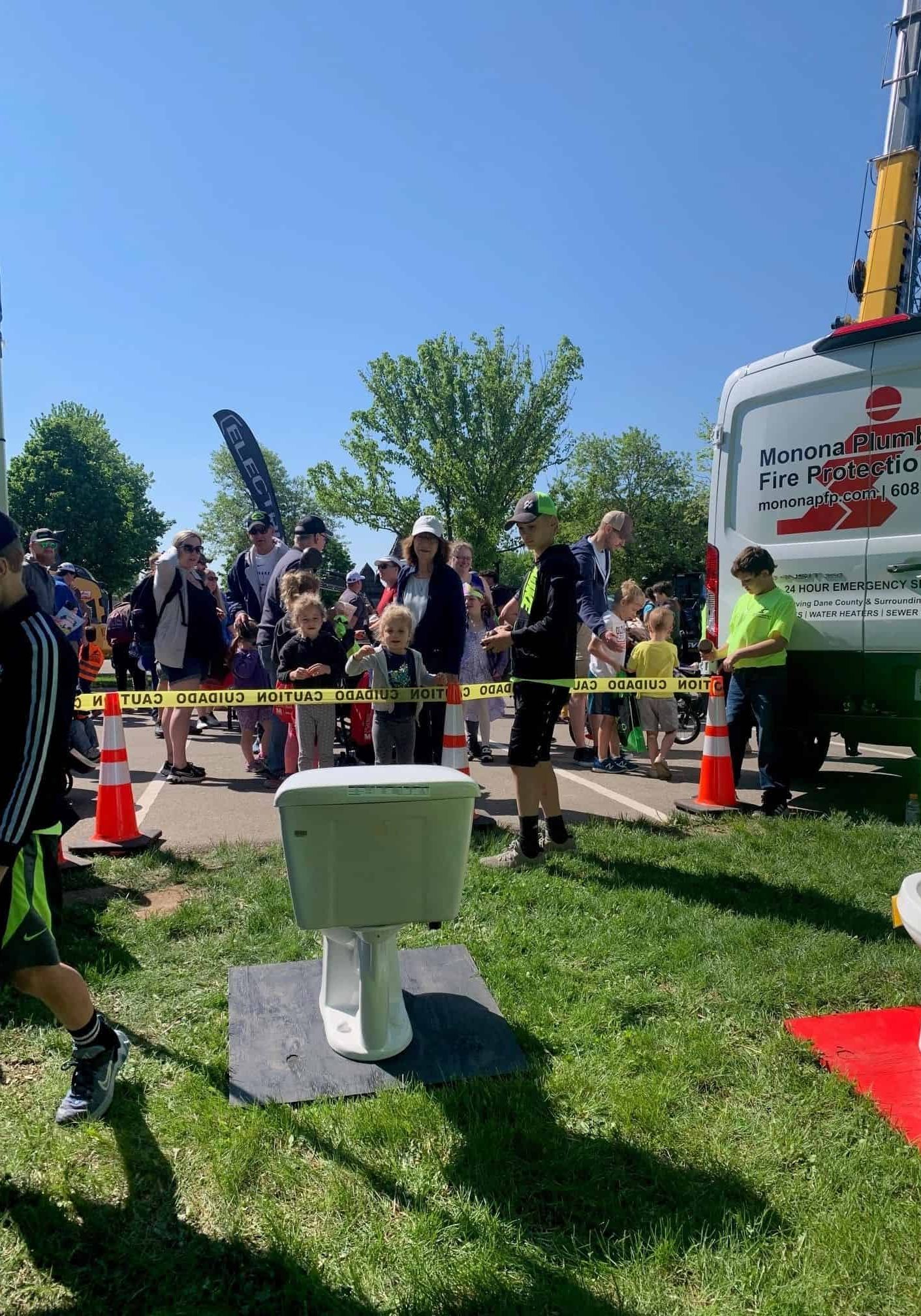 Community event with Monona Plumbing and Fire Protection services, fire safety equipment, and plumbi.