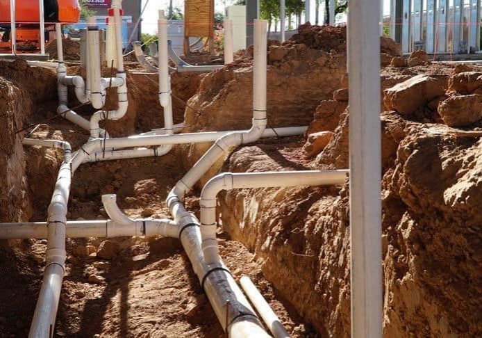 Plumbing pipes installation for fire protection system at construction site.