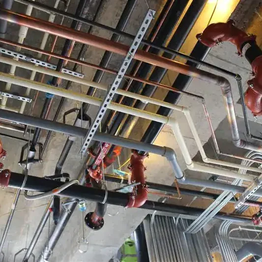 Plumbing and fire protection pipes installed in a commercial building.