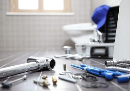 Plumbing and fire protection tools on a workbench in a professional setting.