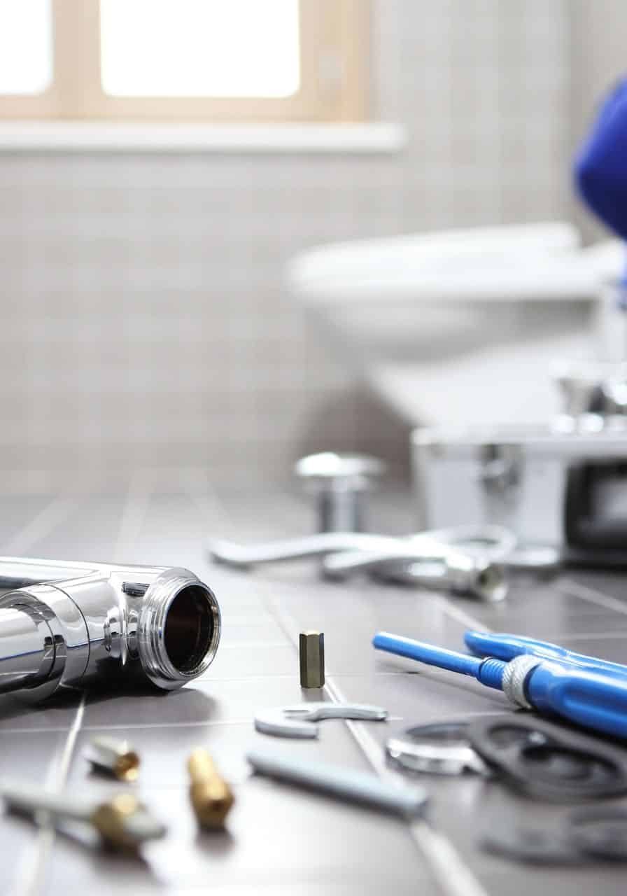Plumbing and fire protection tools on a workbench in a professional setting.