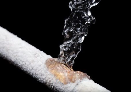 Close-up of water flowing through a pipe for plumbing and fire protection systems.