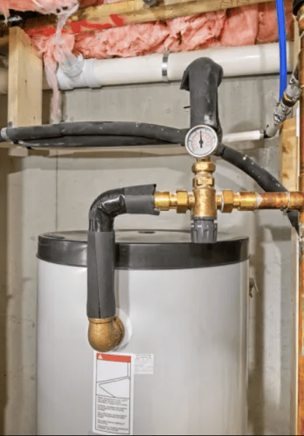 Plumbing and fire protection pipes around water heater in utility room.