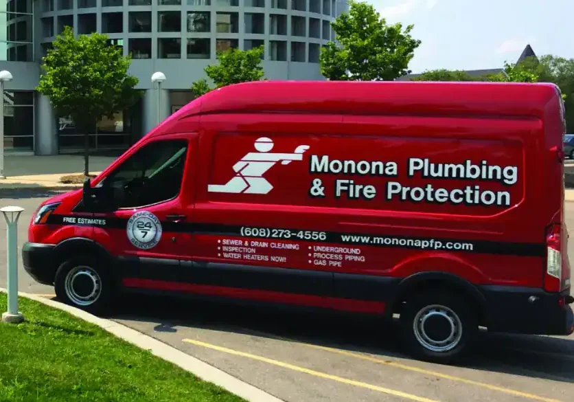 Monona Plumbing and Fire Protection service van with logo and contact info.