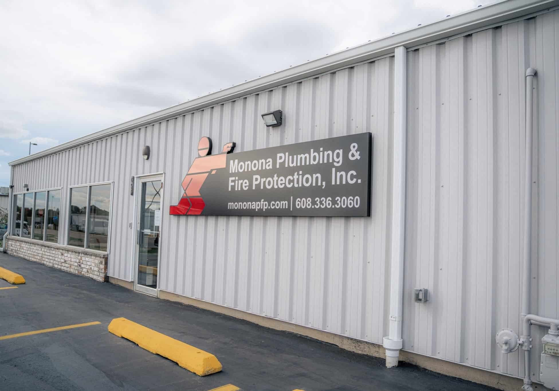 Monona Plumbing and Fire Protection sign on the building exterior.
